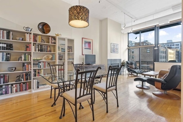 547 S Clark St Unit 704, Chicago, IL 60605 - dining space featuring wood finished floors, a high ceiling, and track lighting