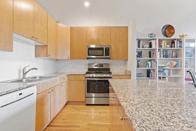 547 S Clark St Unit 704, Chicago, IL 60605 - kitchen featuring appliances with stainless steel finishes, a sink, light stone countertops, and backsplash