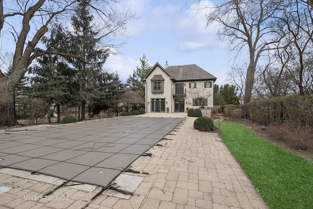 3035 Keystone Rd, Northbrook, IL 60062 - back of property with a chimney, a patio, stone siding, and stucco siding