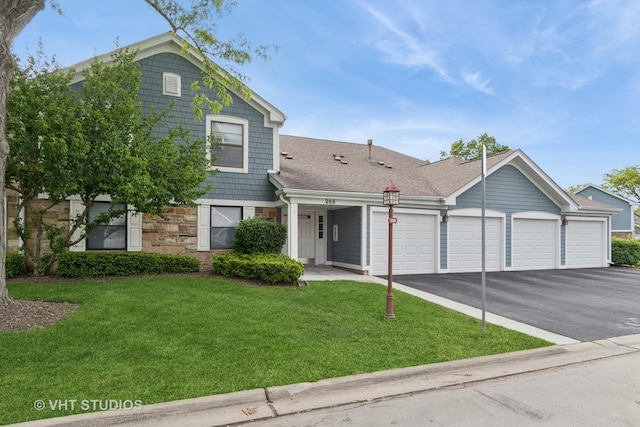 266 Mayfair Ln Unit C1, Schaumburg, IL 60193 - view of front facade featuring an attached garage, driveway, stone siding, and a front yard