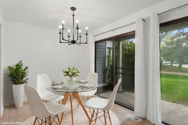266 Mayfair Ln Unit C1, Schaumburg, IL 60193 - dining room featuring a chandelier, light wood-style floors, and baseboards