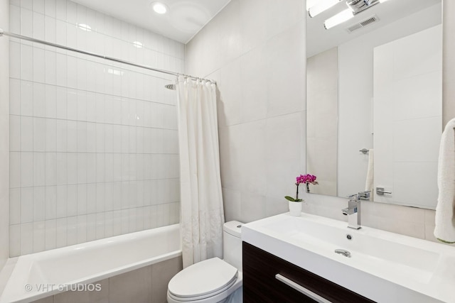 2256 W Foster Ave Unit 3, Chicago, IL 60625 - bathroom featuring tile walls, tiled shower / bath combo, toilet, vanity, and recessed lighting