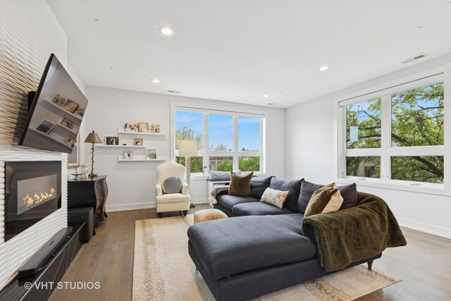 2256 W Foster Ave Unit 3, Chicago, IL 60625 - living room with wood finished floors, a lit fireplace, recessed lighting, and baseboards