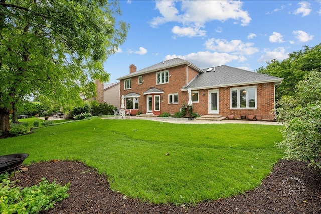 560 Braemar Ave, Naperville, IL 60563 - back of property featuring entry steps, a patio area, brick siding, a yard, and a chimney