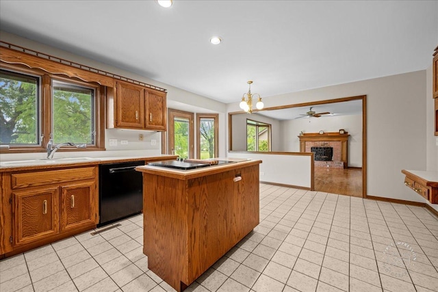 560 Braemar Ave, Naperville, IL 60563 - kitchen featuring black appliances, a fireplace, a center island, a chandelier, and light countertops