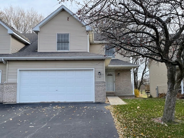 1181 Golf Ct, Dekalb, IL 60115 - traditional-style house with brick siding, driveway, a shingled roof, and a front yard