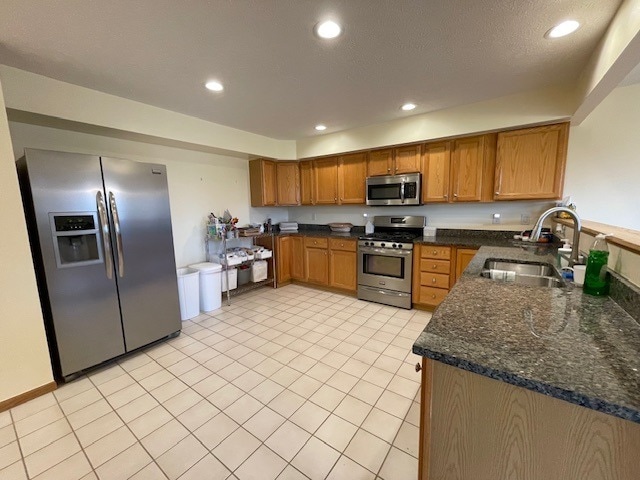 1181 Golf Ct, Dekalb, IL 60115 - kitchen with appliances with stainless steel finishes, a sink, brown cabinets, light tile patterned floors, and recessed lighting