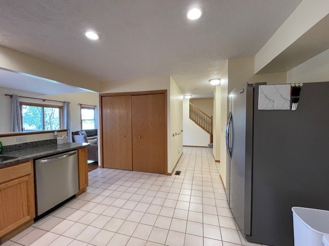 1181 Golf Ct, Dekalb, IL 60115 - kitchen featuring appliances with stainless steel finishes, a textured ceiling, dark countertops, recessed lighting, and brown cabinetry