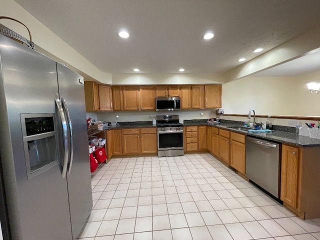 1181 Golf Ct, Dekalb, IL 60115 - kitchen with appliances with stainless steel finishes, a sink, recessed lighting, brown cabinetry, and dark stone counters