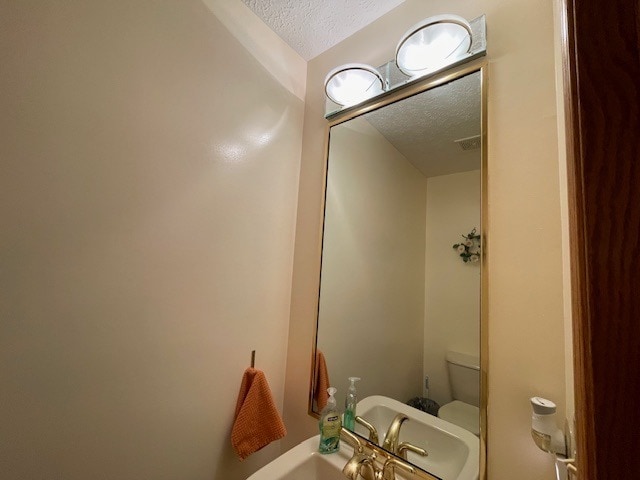 1181 Golf Ct, Dekalb, IL 60115 - half bath with a textured ceiling and toilet