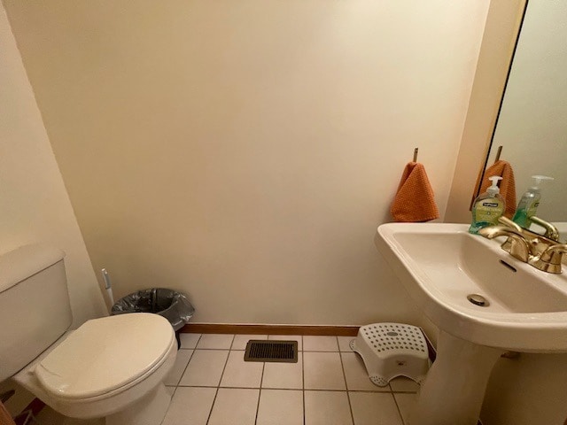 1181 Golf Ct, Dekalb, IL 60115 - half bathroom featuring toilet, tile patterned floors, and baseboards