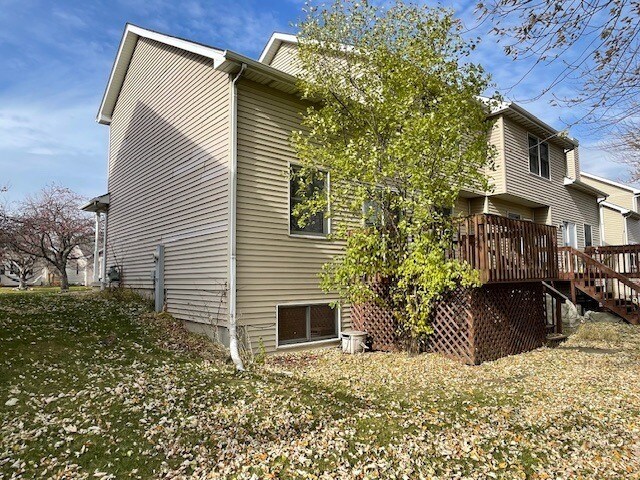 1181 Golf Ct, Dekalb, IL 60115 - back of property featuring a wooden deck and stairs