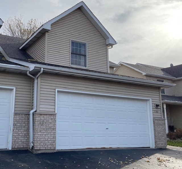 1181 Golf Ct, Dekalb, IL 60115 - view of home's exterior with a garage and brick siding