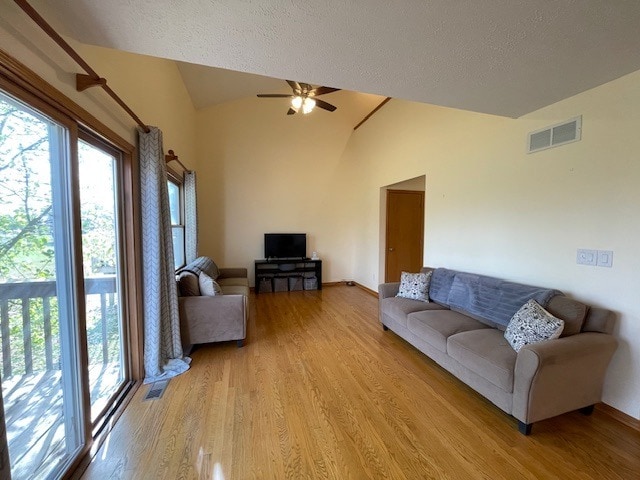 1181 Golf Ct, Dekalb, IL 60115 - living area featuring lofted ceiling, light wood-style floors, a ceiling fan, and a textured ceiling