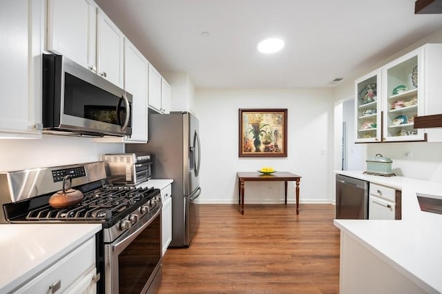 1950 Farnsworth Ln Unit 207, Northbrook, IL 60062 - kitchen with appliances with stainless steel finishes, light countertops, baseboards, white cabinets, and wood finished floors
