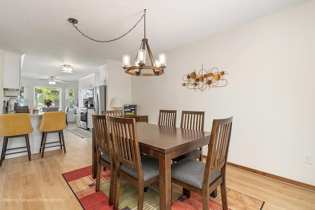 150 Meadows Ct, Sugar Grove, IL 60554 - dining room with light wood finished floors, a chandelier, a ceiling fan, and baseboards