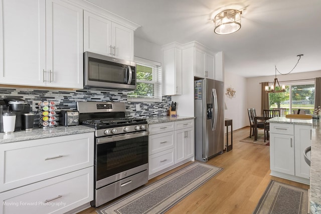 150 Meadows Ct, Sugar Grove, IL 60554 - kitchen featuring appliances with stainless steel finishes, white cabinetry, tasteful backsplash, and light wood-style floors