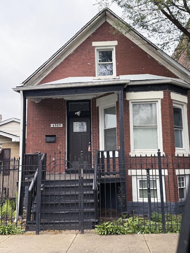 6529 S Laflin St, Chicago, IL 60636 - shotgun-style home with brick siding and a fenced front yard