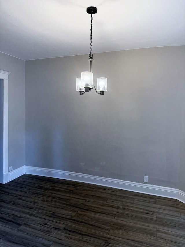 6529 S Laflin St, Chicago, IL 60636 - empty room featuring baseboards, a chandelier, and dark wood-style floors