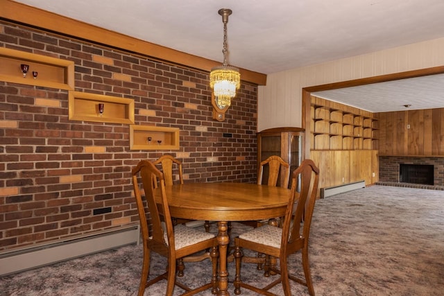 401 N 4th Ave, Chenoa, IL 61726 - dining room with carpet flooring, baseboard heating, brick wall, wood walls, and a brick fireplace