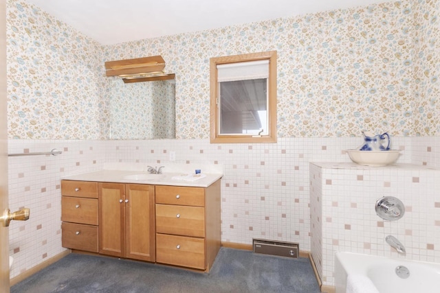 401 N 4th Ave, Chenoa, IL 61726 - bathroom with tile walls, wallpapered walls, vanity, a wainscoted wall, and a bath