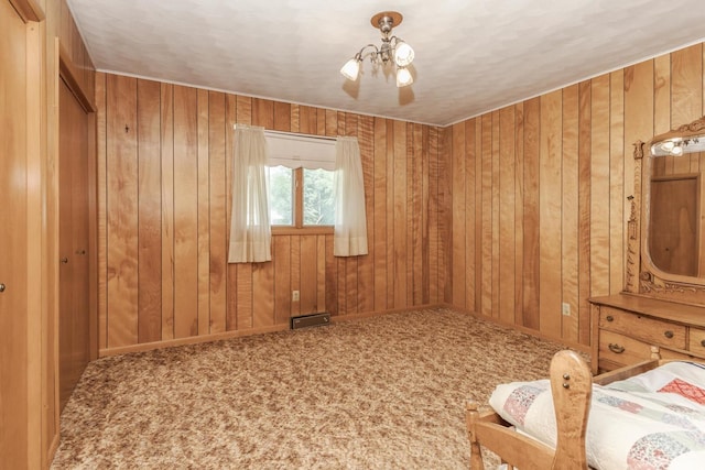 401 N 4th Ave, Chenoa, IL 61726 - unfurnished room with a chandelier, carpet flooring, and wooden walls