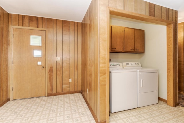 401 N 4th Ave, Chenoa, IL 61726 - washroom with cabinet space, light flooring, washer and clothes dryer, wood walls, and baseboards