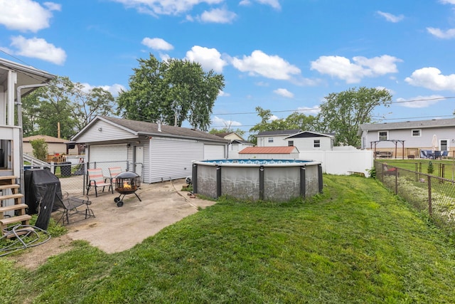 15424 David Ln, Oak Forest, IL 60452 - fenced backyard featuring a detached garage, a residential view, and an outdoor fire pit