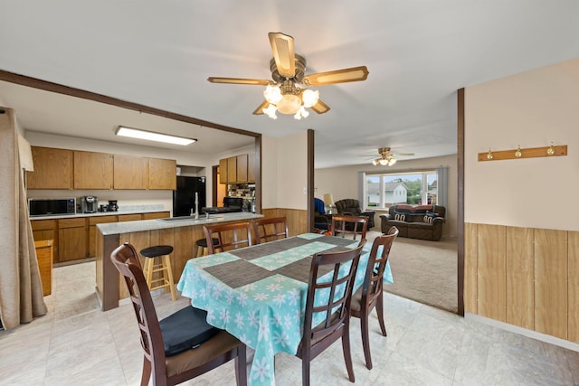 15424 David Ln, Oak Forest, IL 60452 - dining space featuring a ceiling fan, wainscoting, light colored carpet, and light tile patterned floors