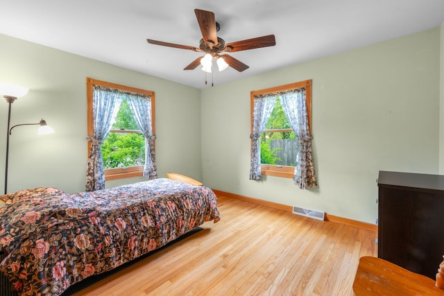 229 N Marion Ave, Bartlett, IL 60103 - bedroom featuring multiple windows, baseboards, hardwood / wood-style floors, and ceiling fan