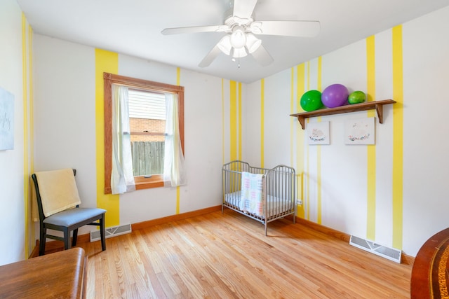 229 N Marion Ave, Bartlett, IL 60103 - bedroom featuring light wood-style flooring, baseboards, wallpapered walls, and a ceiling fan