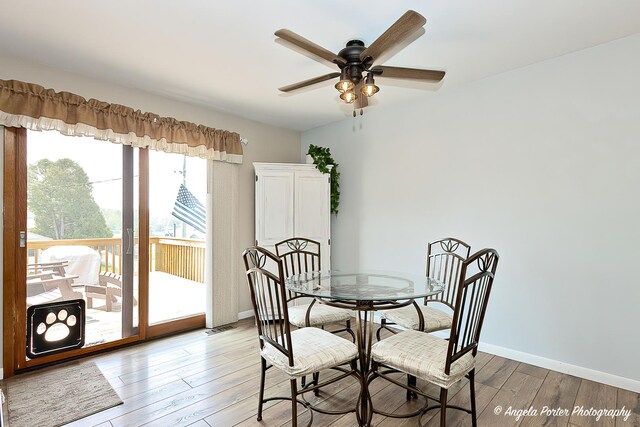 1503 Channel Beach Ave, Johnsburg, IL 60051 - dining room featuring ceiling fan, light wood finished floors, and baseboards