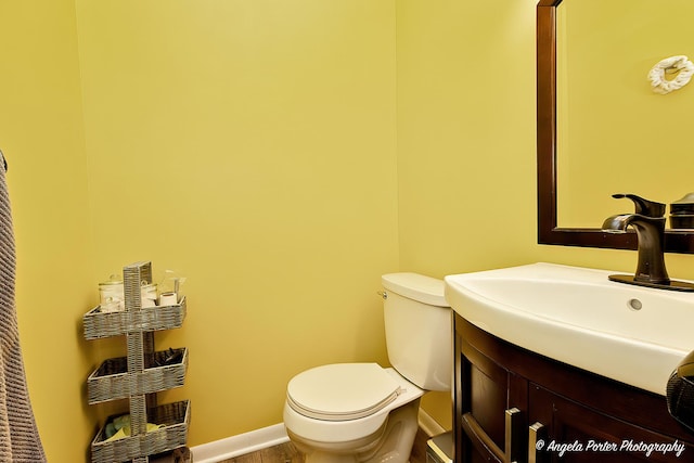 1503 Channel Beach Ave, Johnsburg, IL 60051 - half bathroom featuring toilet, vanity, and baseboards
