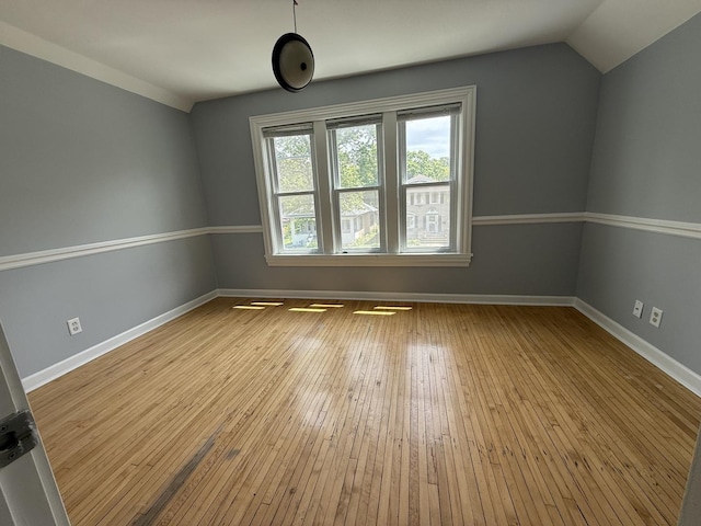 509 S May St, Joliet, IL 60436 - empty room with vaulted ceiling, hardwood / wood-style floors, and baseboards