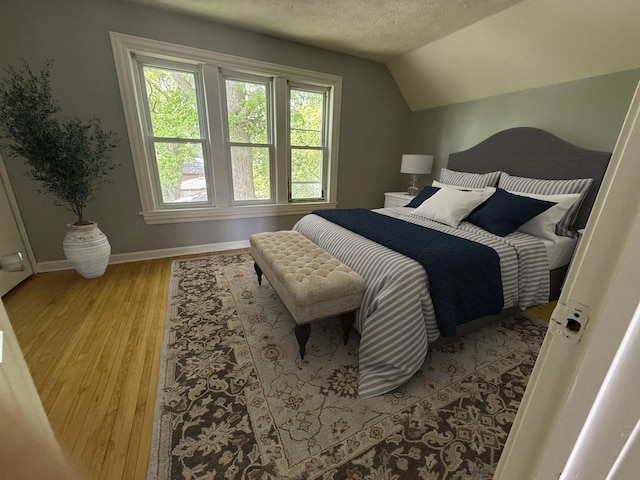 509 S May St, Joliet, IL 60436 - bedroom featuring wood finished floors, baseboards, lofted ceiling, and a textured ceiling
