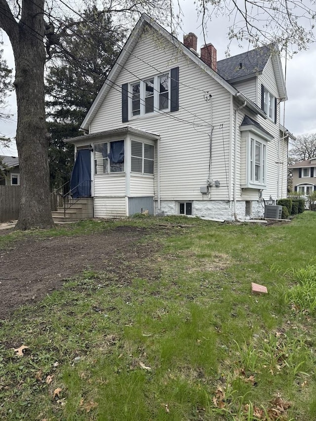 509 S May St, Joliet, IL 60436 - back of property featuring a chimney and central air condition unit
