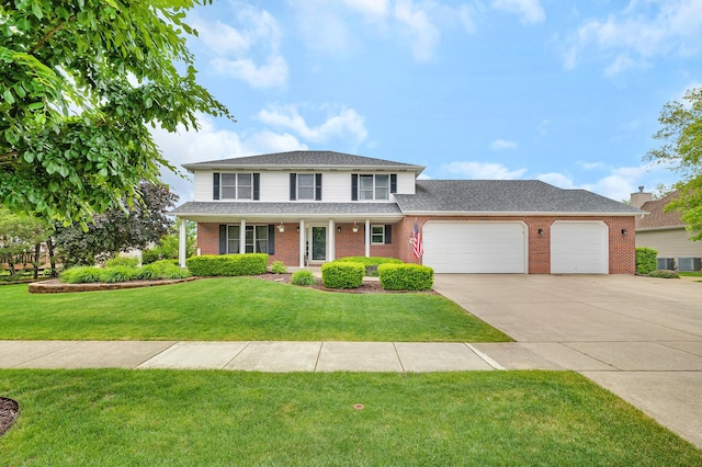 605 Feeney Dr, Minooka, IL 60447 - traditional-style home with a garage, brick siding, driveway, and a front yard
