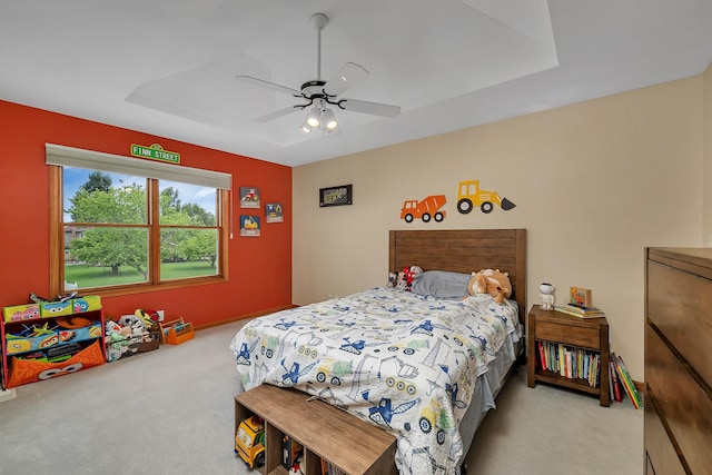 605 Feeney Dr, Minooka, IL 60447 - carpeted bedroom featuring a ceiling fan, baseboards, and a tray ceiling