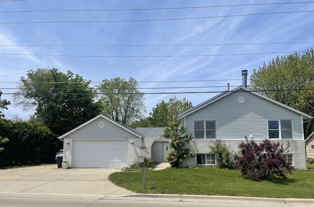 3400 N Buffalo Grove Rd, Arlington Heights, IL 60004 - view of front of house with brick siding, an attached garage, concrete driveway, and a front yard
