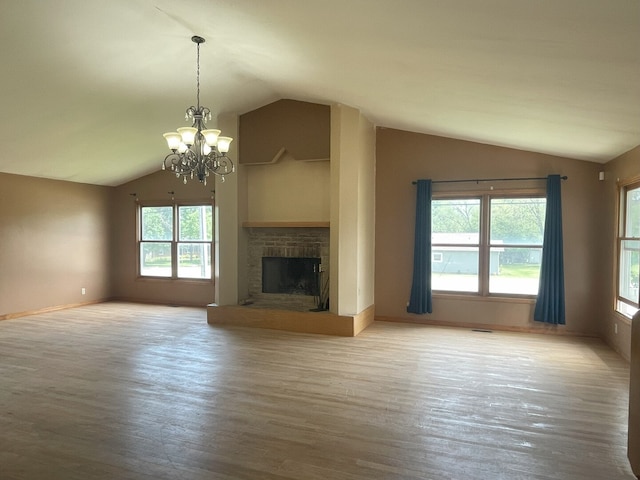 3400 N Buffalo Grove Rd, Arlington Heights, IL 60004 - unfurnished living room with lofted ceiling, a chandelier, a stone fireplace, wood finished floors, and baseboards
