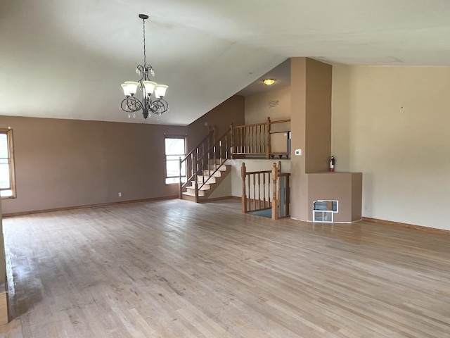 3400 N Buffalo Grove Rd, Arlington Heights, IL 60004 - unfurnished living room with wood finished floors, a chandelier, stairway, vaulted ceiling, and baseboards