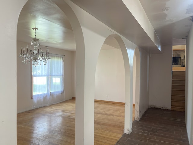 3400 N Buffalo Grove Rd, Arlington Heights, IL 60004 - empty room featuring wood finished floors, a chandelier, stairway, and baseboards
