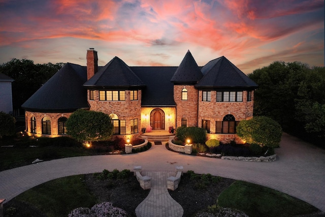 45 Silo Ridge Rd, Orland Park, IL 60467 - french country home with a chimney, curved driveway, and stone siding