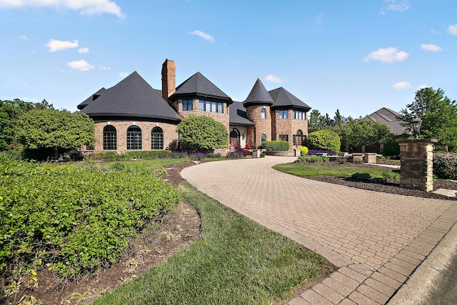 45 Silo Ridge Rd, Orland Park, IL 60467 - french country inspired facade with curved driveway, a chimney, and brick siding
