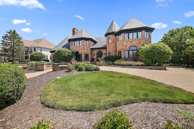45 Silo Ridge Rd, Orland Park, IL 60467 - view of front of house featuring brick siding, a high end roof, a front yard, a chimney, and stone siding