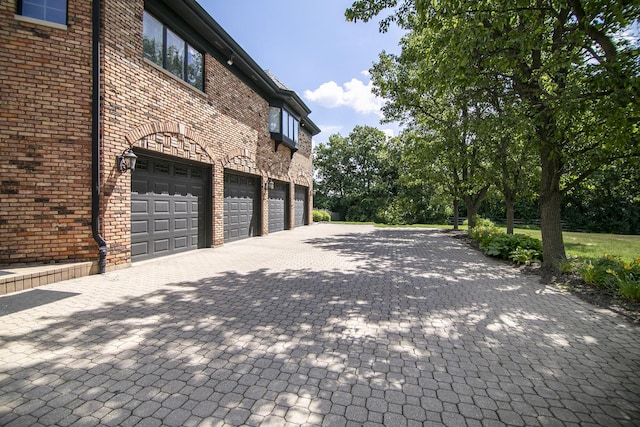 45 Silo Ridge Rd, Orland Park, IL 60467 - view of home's exterior featuring an attached garage, decorative driveway, and brick siding