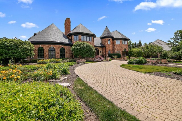 45 Silo Ridge Rd, Orland Park, IL 60467 - view of front of home with brick siding, a chimney, and curved driveway