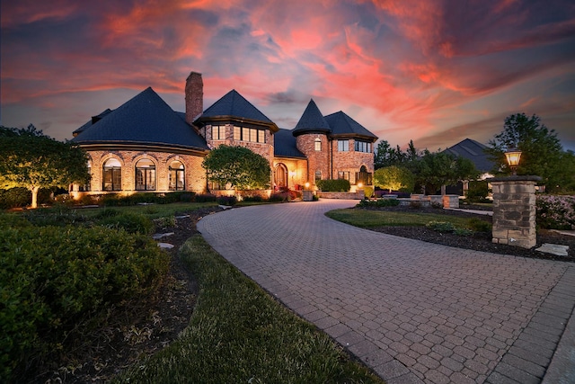 45 Silo Ridge Rd, Orland Park, IL 60467 - french country style house featuring curved driveway, a chimney, and stone siding