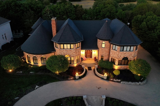 45 Silo Ridge Rd, Orland Park, IL 60467 - view of front of home with stone siding, a chimney, and curved driveway