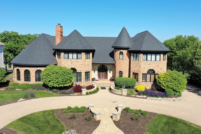 45 Silo Ridge Rd, Orland Park, IL 60467 - french country home with a chimney, brick siding, and stone siding